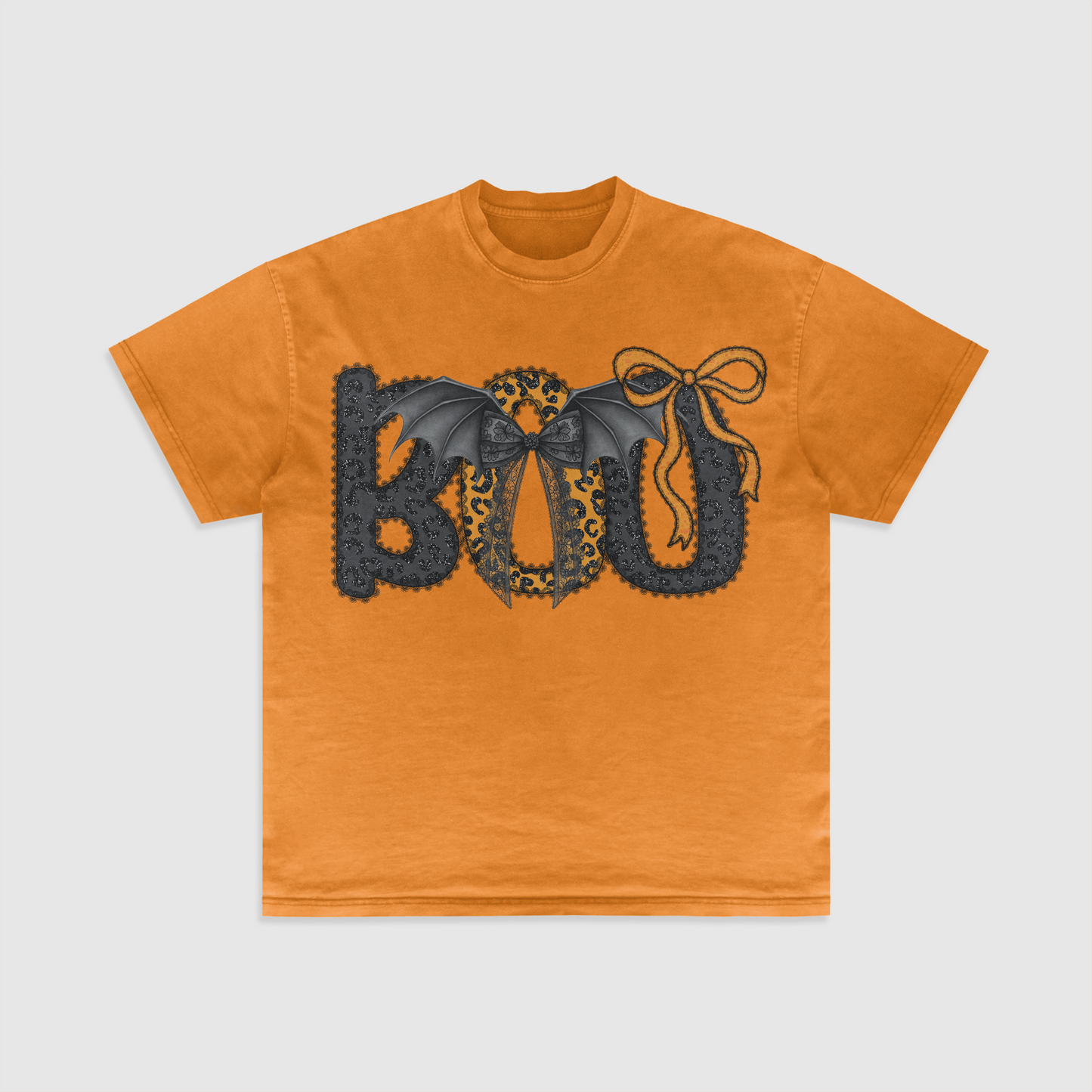 Orange t-shirt with decorative 'BOO' design on a light gray background