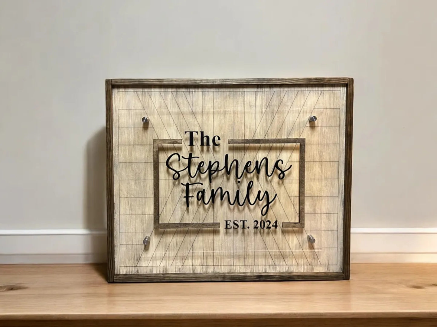Wooden plaque with 'The Stephens Family EST. 2024' text on a wooden surface. All of our custom signs are one offs. We work directly with you to pick out the design that truly speaks to you!