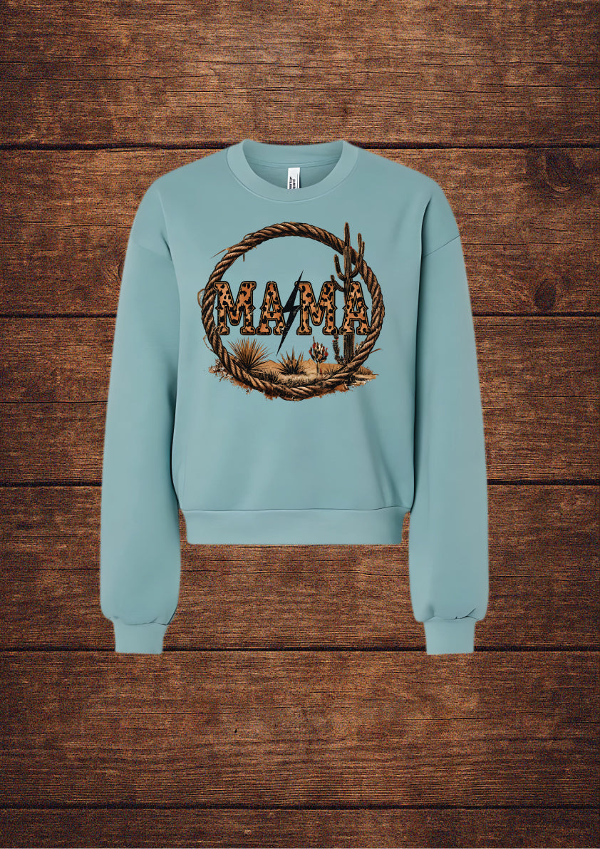 Light blue sweatshirt with 'MAMA' graphic on a wooden background