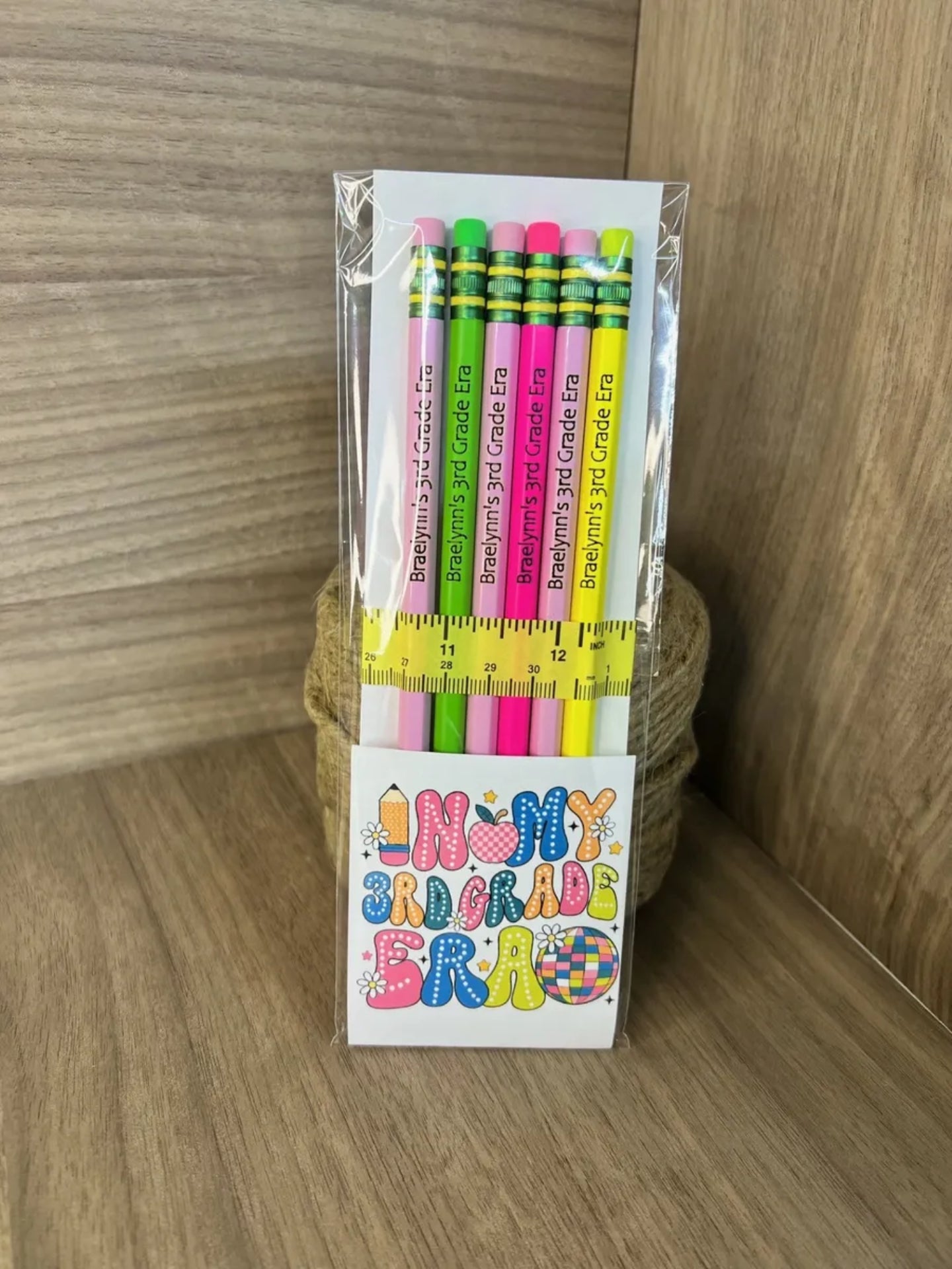 Pack of colorful pencils with a branded box on a wooden surface