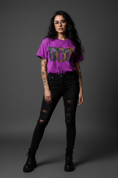 Purple t-shirt with Halloween-themed design with the word "BOO" on the front with bats and a cute bow.