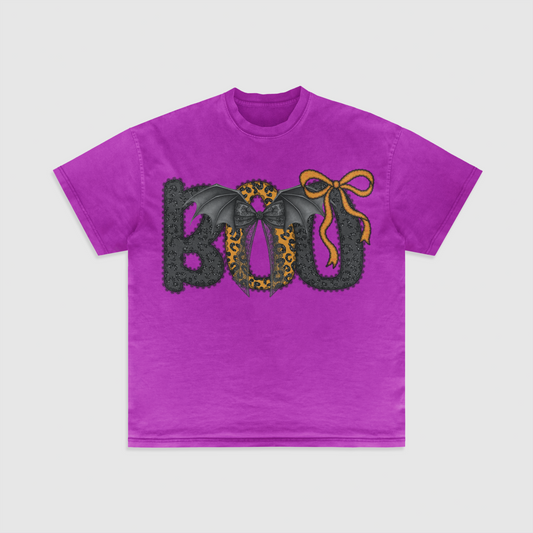 Purple t-shirt with Halloween-themed design with the word "BOO" on the front with bats and a cute bow.