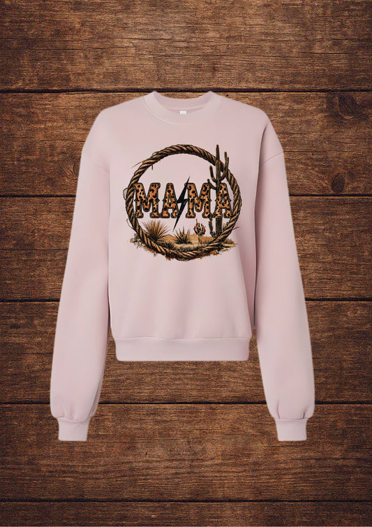 Pink sweatshirt with a graphic design on a wooden surface