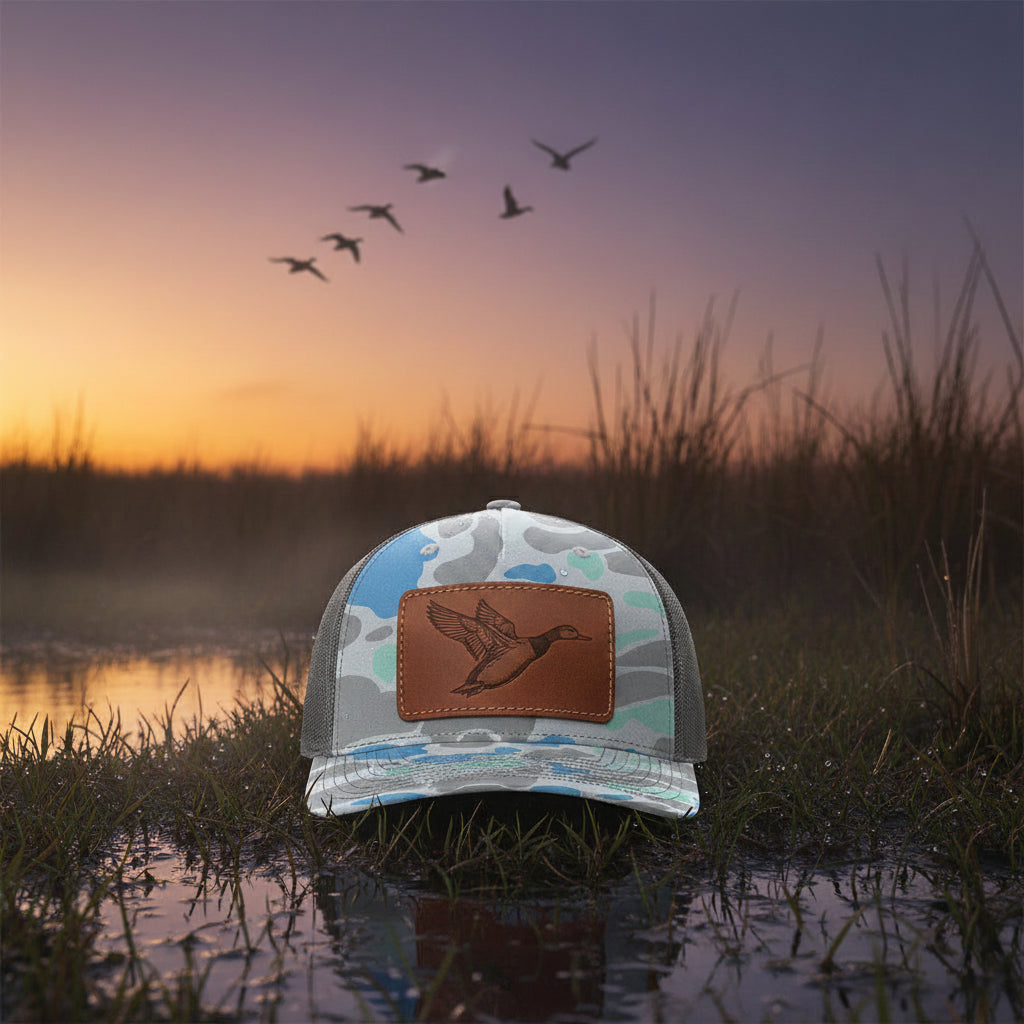 Camouflage-patterned cap with mesh back on a white background